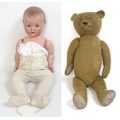 A German bisque headed doll together with a plush teddy bear, doll measures 69cm long and bear 60cm ... 