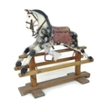 A small early to mid 20th century rocking horse, carved wooden body painted dapple grey with red sad... 