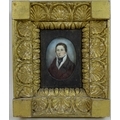 An early 19th century miniature portrait on ivory, depicting a man in brown coat, white shirt and bl... 