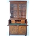 A George III inlaid mahogany secretaire bookcase, the flared cornice above vase and leaf scroll deco... 