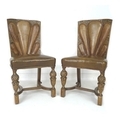 A pair of unusual early to mid 20th century chairs, the backs with lobed leather upholstered backs, ... 