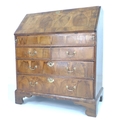 A late 17th century walnut oyster veneered bureau, herringbone crossbanded, fall front with fitted i... 