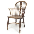 A 19th century oak and elm Windsor chair, low rounded back with pierced splat and stick supports, cr... 