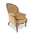 A Victorian mahogany and walnut framed armchair, carved and moulded frame, serpentine front rail, lo... 