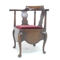 An early 19th century mahogany corner chair, shaped outscrolling arms, vase and turned splats, red v... 