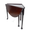 A 19th century mahogany corner drop leaf table, the triangular surface with moulded upstand with sem... 