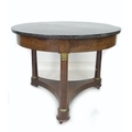 A Regency centre table, mahogany veneered, with circular black marble surface supports on a plain fr... 