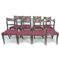 A harlequin set of eight Regency bar back dining chairs, with brass inlaid top rails, spiral carved ... 