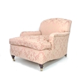 A Victorian style club armchair, in the style of Howard & Sons, upholstered in dusty pink fabric, ra... 