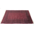 A Tekke rug with red ground, three rows of twelve medallions, 160 by 250cm.