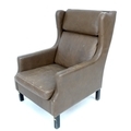 A retro Danish wing armchair in the style of Borge Mogensen, upholstered in brown leather, 68 by 93 ... 