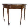 An early 19th century mahogany and inlaid tea table, of semi circular form with fold over top, kick ... 