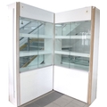 A large modern shop display cabinet, in two sections, white covered MDF and glass panels, with six s... 