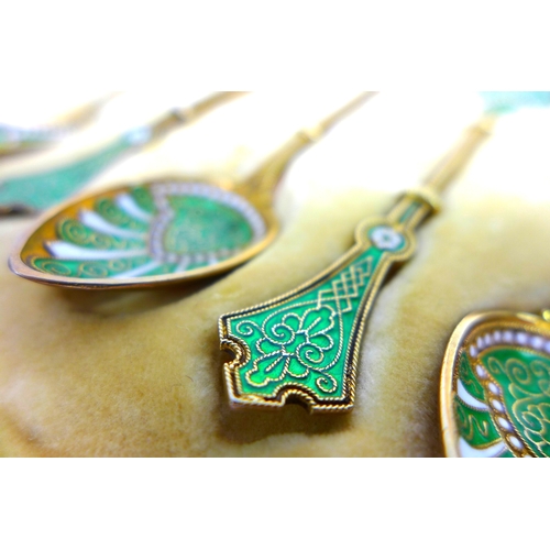 22 - A set of six Art Nouveau Norwegian silver-gilt and green and white enamel teaspoons, marked WFB, lik... 