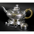 A George III silver teapot, decorated in Rococo style with repousse foliate and floral scrolls, Rich... 