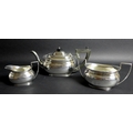 A George V silver three piece tea service, London shape, comprising teapot, twin handled sugar bowl,... 