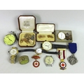 A collection of medals, badges, watches and cufflinks, including a pair of 9ct gold cufflinks, engin... 