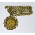 An Elizabeth II gold sovereign, in 9ct gold mount and 9ct gold chain, 33mm across, chain 56cm long, ... 