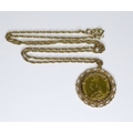 A Victoria old head gold sovereign, 1889, in a 9ct gold scroll mount, and on 9ct gold chain, 64cm, 1... 