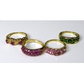 Private Collection-Vintage and Modern design rings: A group of four 9ct gold bands set with gemstone... 