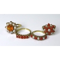 Private Collection-Vintage and Modern design rings: A group of 9ct gold rings set with orange stones... 