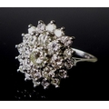 Private Collection-Vintage and Modern design rings: An 18ct white gold and diamond flowerhead ring, ... 