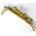 A Victorian 15ct gold fox stock pin, modelled with a running fox above a hunting crop, 7.3g, in orig... 