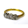 An 18ct gold and platinum and diamond three stone ring, the diamonds illusion set, approximately 0.2... 