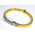 A 14ct white and yellow gold bracelet, central hinged white gold detailing with yellow gold arms, ma... 