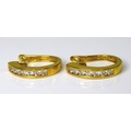 A pair of 18ct gold and diamond earrings, of hooped form each with set with six brilliant cut diamon... 