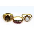 A group of three rings, one set with five oval garnets, unmarked but tests as 14ct gold, size J, 2.4... 
