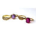 A group of four rings, one set with amethyst, another with a pink stone, size J through to O, only o... 