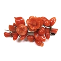 A Victorian carved red coral brooch, the pieces of coral carved as leaves, flowers and acorns, mount... 