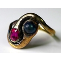An 18ct gold, Russian ruby and sapphire cabochon ring, in the form of two snakes, size P, 4.7g, with... 