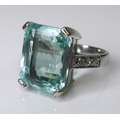 An 18ct white gold and aquamarine ring, the central emerald cut stone 15 by 11mm, the shoulders set ... 