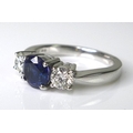 An 18ct white gold, sapphire and diamond three stone ring, the central royal blue sapphire of approx... 