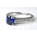 An 18ct white gold and sapphire ring, the 0.9ct brillant cut royal blue sapphire flanked by diamond ... 