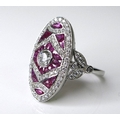 An 18ct white gold, diamond and ruby dress ring, the central brilliant cut diamond of approximately ... 