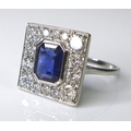 An 18ct white gold, sapphire and diamond Art Deco style ring, the emerald cut central sapphire of ap... 