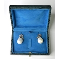 A pair of pearl and diamond drop earrings, each formed as a diamond set bow with a large drop pearl ... 