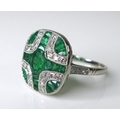An Art Deco style emerald and diamond ring, formed of brilliant cut diamonds and princess cut emeral... 