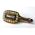 A Victorian yellow metal mourning brooch in a Halley's Comet design, set with seed pearls and a ruby... 