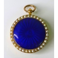 An Edwardian 18ct gold, pearl and enamel locket, the royal blue guilloche enamelled centre surrounde... 