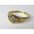 An 18K gold and diamond ring, set with a central stone of approximately 0.25ct in a textured claw se... 