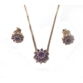 A 9ct rose gold and amethyst necklace and earrings set, of daisy design, 5.1g total. (3)
