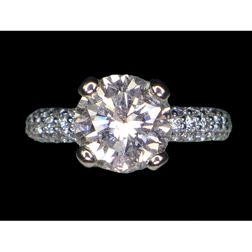 310 - A large and impressive platinum and diamond solitaire ring, the brilliant cut diamond approximately ... 