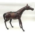 A modern sculpture of a racehorse, leather covered, 71 by 67cm high.