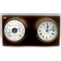 A Foster Callear duo of quartz clock and barometer, each in circular brass frames, attached to a rec... 