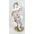A large 19th century porcelain figurine, emblematic of Summer, modelled as a lady in a pink dress fl... 