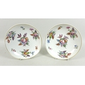 A pair of Derby porcelain dishes, circa 1820, decorated with sprays of flowers, gilt rims, red paint... 